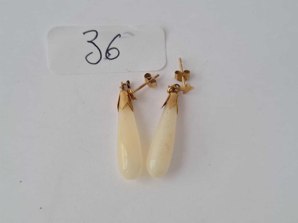 A pair of M.O.P gold top earrings