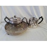 An oval teapot another and a tray