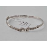 A white gold bangle set with white stones (one missing) 9ct - 5.4 gms