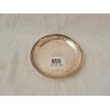 A circular saucer dish with raised rim, London 1933, w.58g