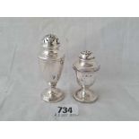 Two urn shaped peppers with reeded rims - one London 1895 - both weigh 66 g.