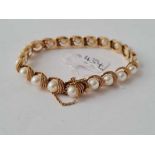 A GOOD PEARL SET BRACELET 14CT GOLD - 21.3 GMS