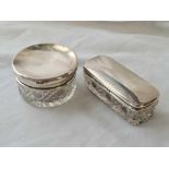 Two silver topped jars with glass bodies