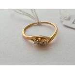 A three stone diamond ring 18ct gold size N - 1.8 gms