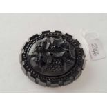 A very large Victorian carved grapes jet brooch
