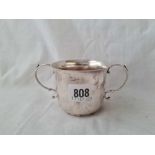 A plain two handled porringer - 5" over handles - London 1910 - 99 g.