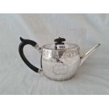 A Victorian oval teapot with bright cut decoration - Exeter 1870 by TS - 421 g.