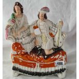 Staffordshire group of two figures, the man with mandolin 10 inch high