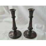 A pair of candlesticks with baluster shaped stems.