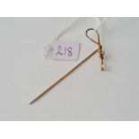 A unusual arts and crafts stick pin in the form of a riding crop with opal and pearl stones