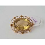 A fancy mounted brooch with large oval central citrine 9ct - 9.1 gms total citrine 2cm x 1.5 cm