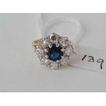 . LARGE SAPPHIRE AND DIAMOND CLUSTER RING SET IN 18CT GOLD (MARKED IN SHANK). DIAMOND CONTENT 1.2