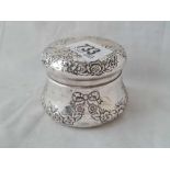 A circular jar and cover embossed with ribbons - 3" diameter - probably Birmingham 1904 - 66 g.