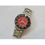 A GENTS TAG HUER FORMULA 1 PROFESSIONAL 200M WRIST WATCH with red dial and black bezel with