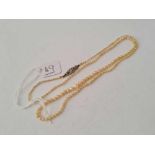 AN EDWARDIAN NATURAL SEED PEARL NECKLACE WITH 18CT GOLD DIAMOND CLASP