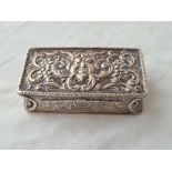 Unusual Georgian snuff box with chased cover and mask decorated cornices. 3.5 inch wide. London 1831