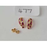 A pair of red and white stone earrings 9ct