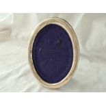 Oval photo frame with import mark.