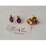 A pair of 9ct citrine stud earrings and a pair of amethyst and diamond stud earrings