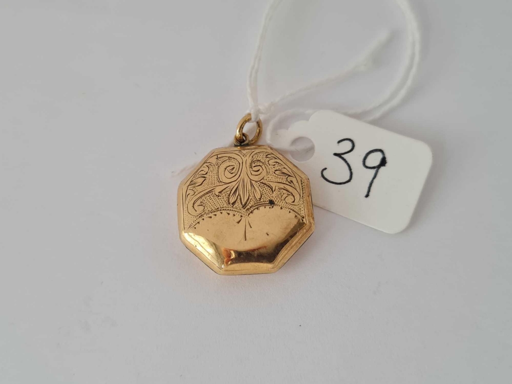 An octagonal floral engraved back & front locket