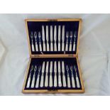 A good boxed set of twelve fruit knives and forks with MOP handles in fitted walnut case - Sheffield