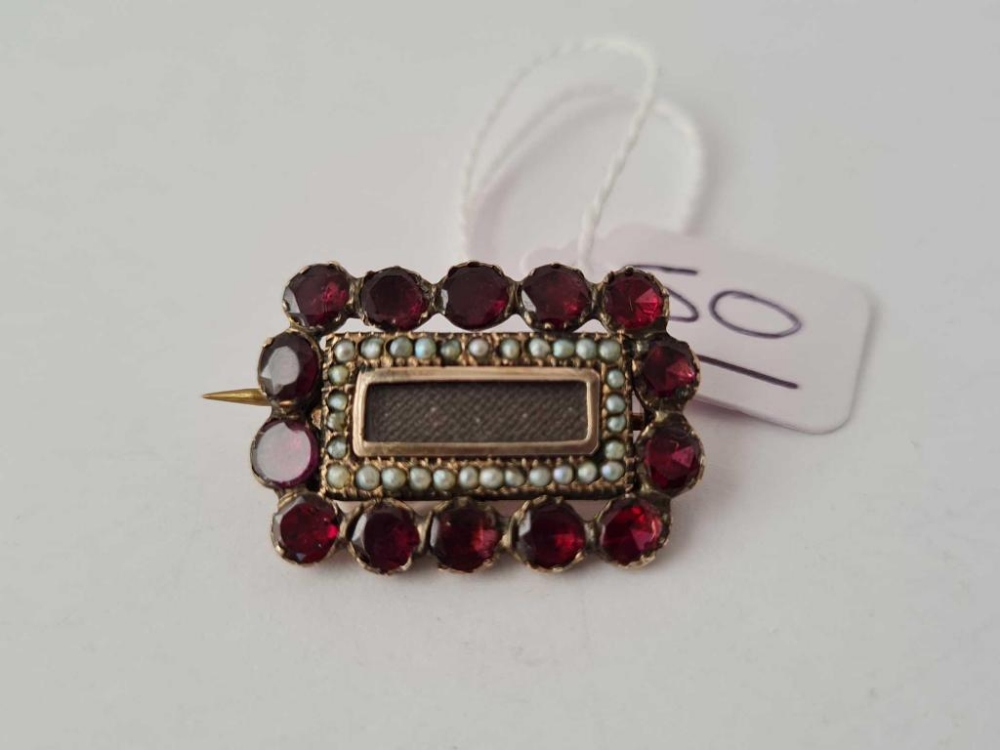 A Georgian garnet and pearl gold memorial brooch