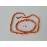 A single string of graduated coral beads