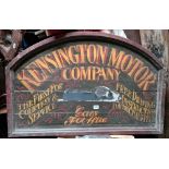 An arched top wooden advertising board for Kensington Motor Company, size 36” x 24”