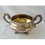 A Victorian sugar bowl with two leaf capped handles, scroll feet, 8.5" over handle, 1833 by E,EJ & W