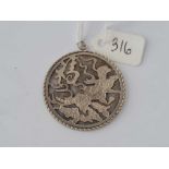 A rare early hand crafted highly detailed double sided oriental silver pendant