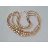 A triple strand pearl necklace