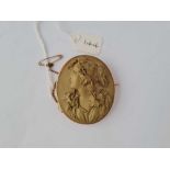 A VICTORIAN LAVA CAMEO BROOCH MOUNTED IN GOLD DEPICTING A WOMEN WITH GRAPES AND VINES IN HER