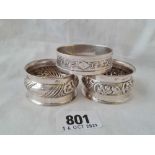 A pair of napkin rings with embossed decoration, B'Ham 1904 & another