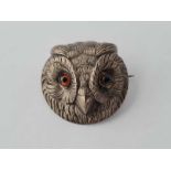 A metal owl brooch