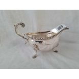 A heavy oval sauce boat with gadrooned rim and pad feet - 7" long - London 1946 - 275 g.