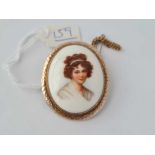 A pinchbeck plaque brooch of a pretty lady
