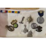 Nine various badges, medals etc