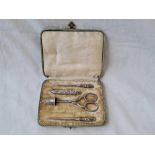 A boxed manicure set with silver mounted implements