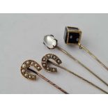 A Victorian gold onyx stick pin and three others pearl set and moonstone