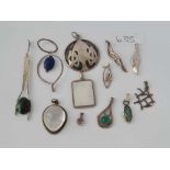 Twelve assorted silver pendants - 53 gms