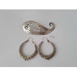 A very large striking silver brooch and a pair of very large hoop silver earrings 38.8g