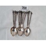 A set of twelve coffee spoons with figure finials, unmarked, 59g