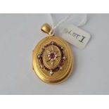 A attractive Victorian oval locket front with ruby's and pearls hinge centre with two photo