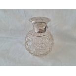 A scent bottle en-suite, with cut glass body & stopper