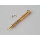 A gold cased propelling pencil with onyx terminal