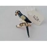 A metal parrot brooch with distressed enamel plumage