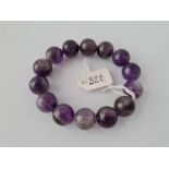 A fourteen amethyst bead bracelet