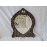 A large easel shaped dressing table mirror with heart shaped mirror panel, embossed scroll boarder