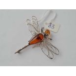 A white metal bug brooch the head and body set in amber
