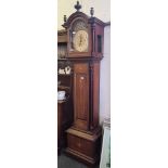 A good large Edwardian chiming long case clock with arched brass dial and bells.